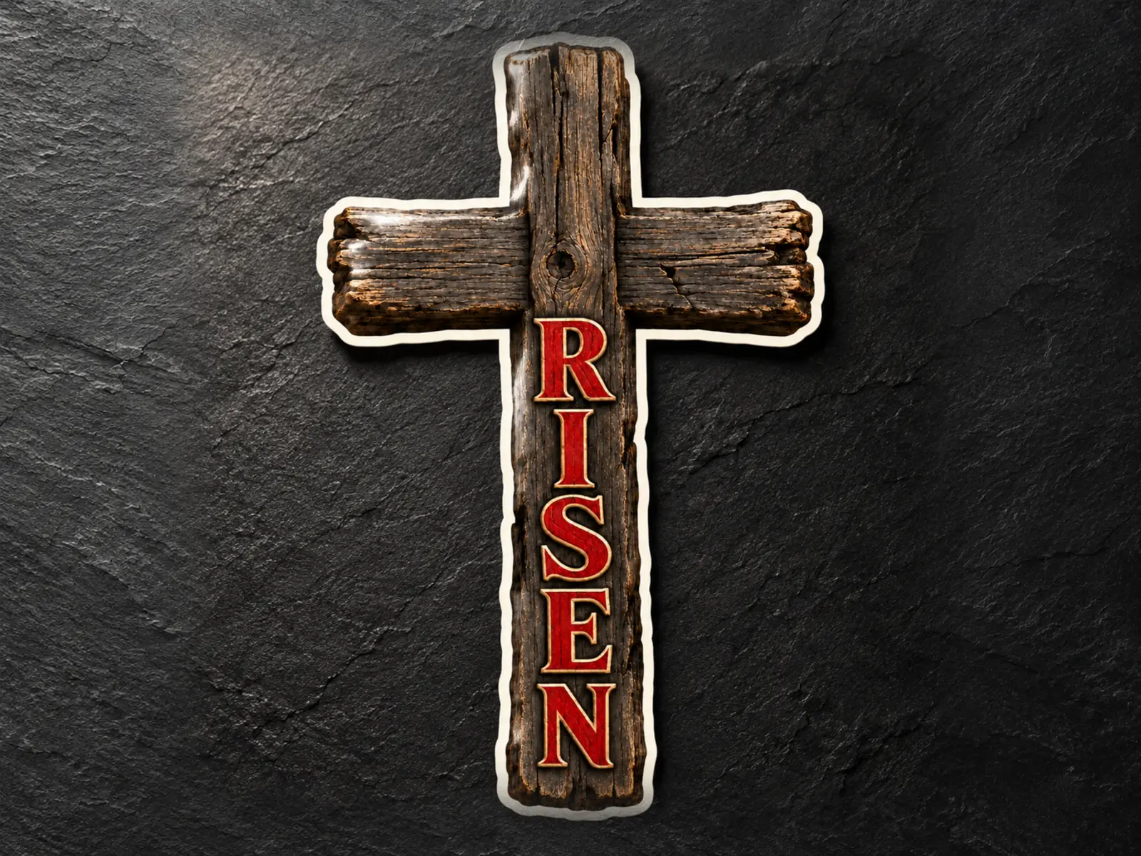 Weathered wooden cross sticker with RISEN in red lettering on dark slate